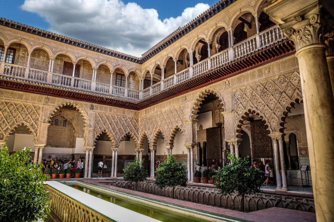 The Alcázar of Seville is a royal palace in Seville, Spain, originally a Moorish fort. It is the oldest royal palace still in use in Europe, and it was registered in 1987 by UNESCO as a World Heritage Site, along with the Seville Cathedral and the General Archive of the Indies