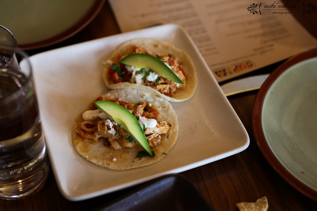 Chicken Tinga rotisserie chicken, tomatoes, chipotle, avocado, queso fresco, crema, cilantro